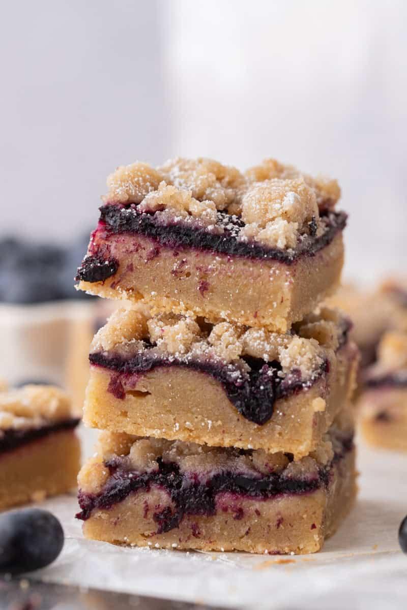 Close-up of a single blondie bar with berries, showcasing the texture and color