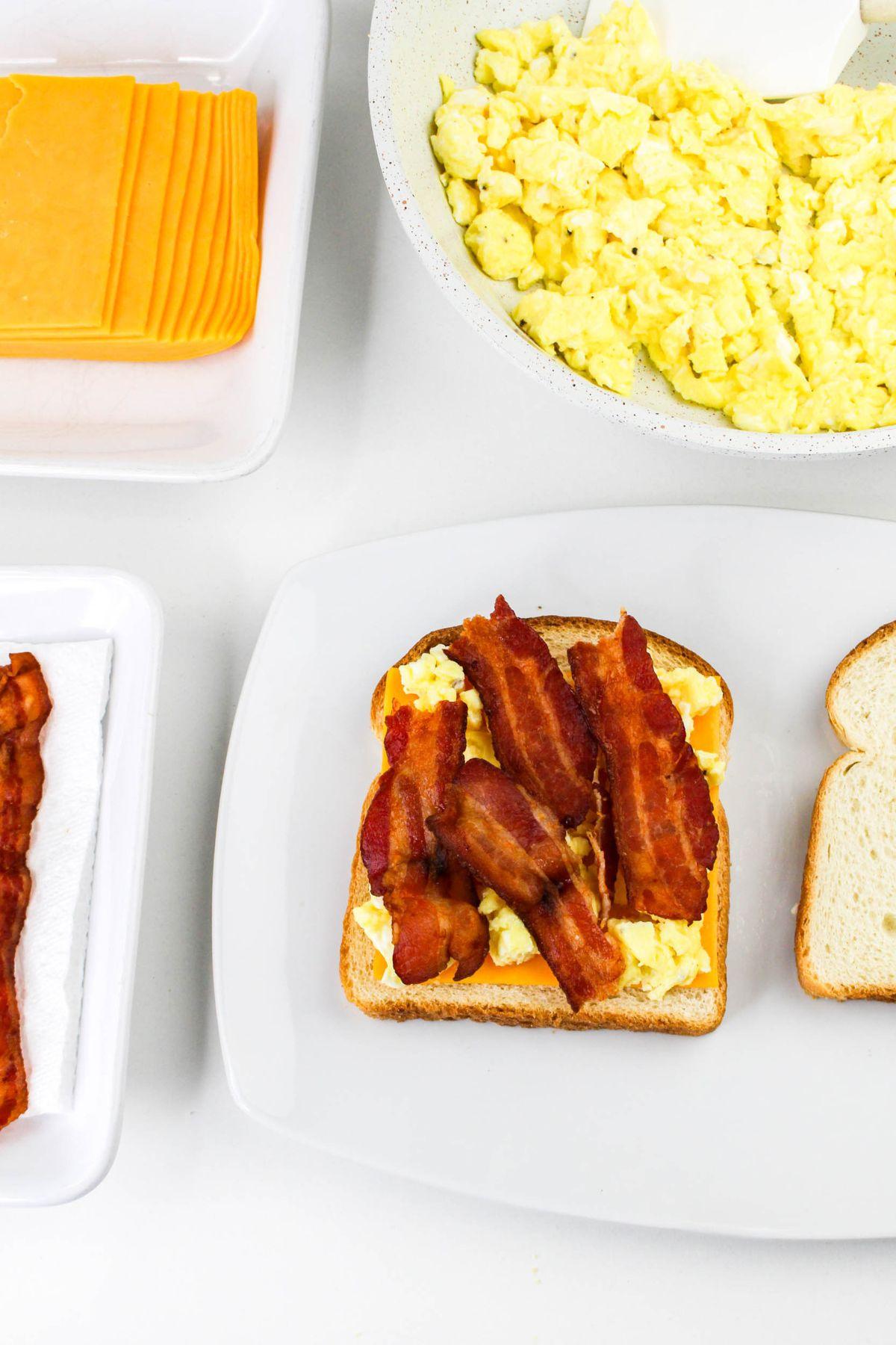 cooked bacon slices next to bowl of cheese