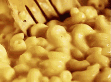close up of mac and cheese being stirred