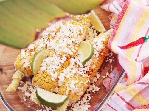 close up shot of elote and cotija scallops on a serving plate