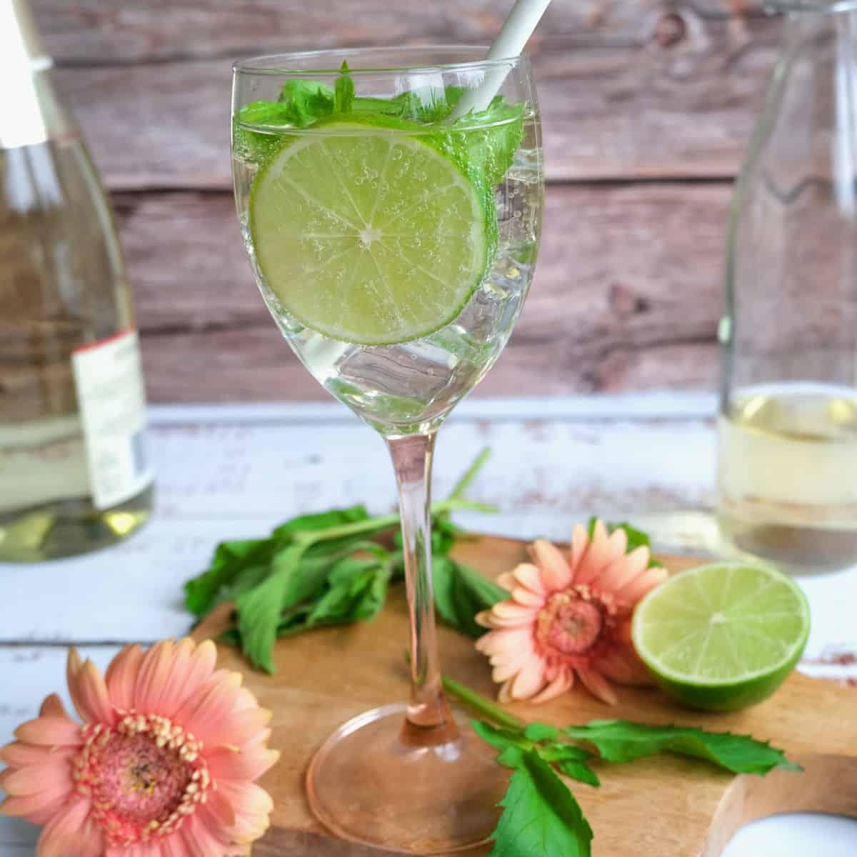 plum cardamom hugo cocktail in a clear glass