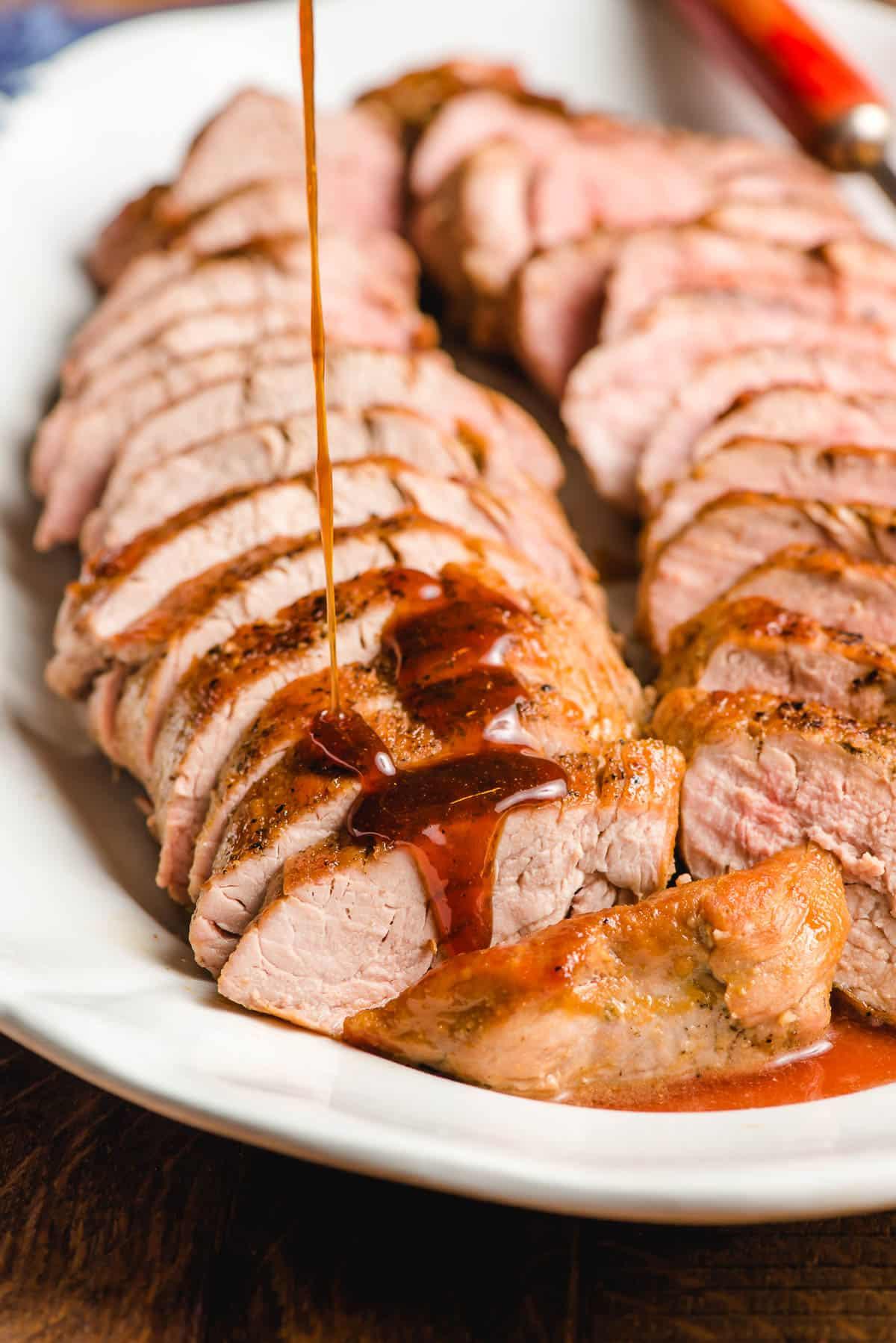 sliced pork tenderloin on a serving platter