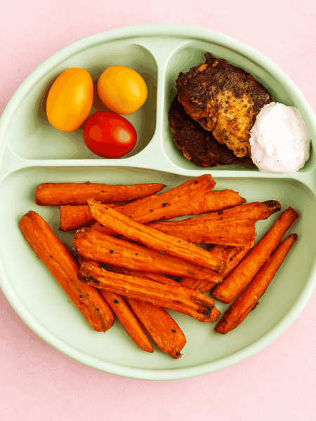 a child happily eating carrot fries with avocado ranch, showcasing the recipe's kid-friendly appeal