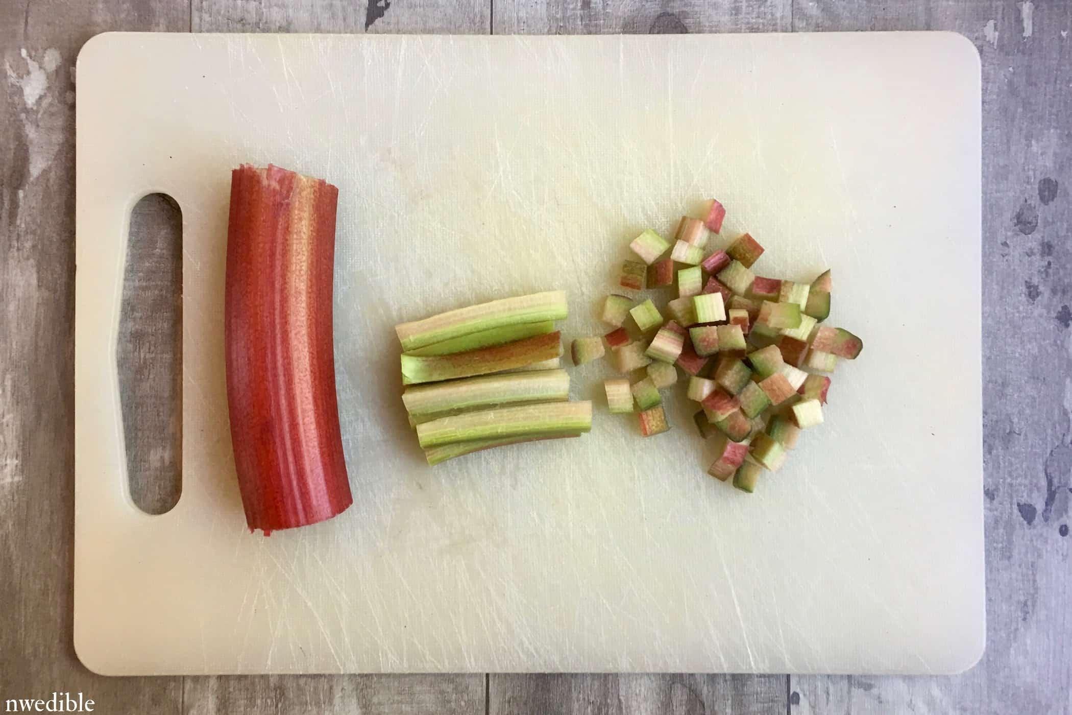 chopped rhubarb, chili peppers, lime, and cilantro on a cutting board