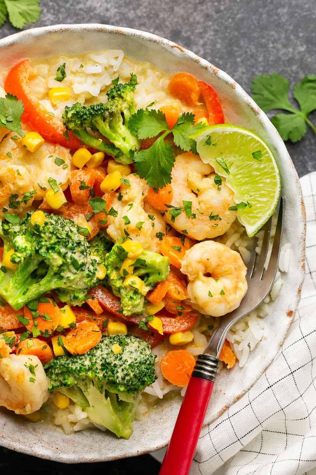 Close up shot of the creamy coconut curry with shrimp and vegetables being stuffed into a bell pepper