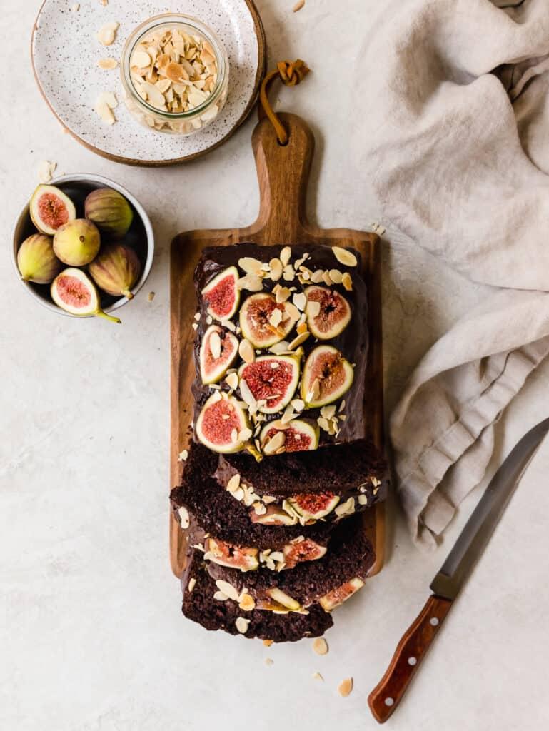 Fig balsamic chocolate cake on a rustic wooden table with figs and balsamic glaze