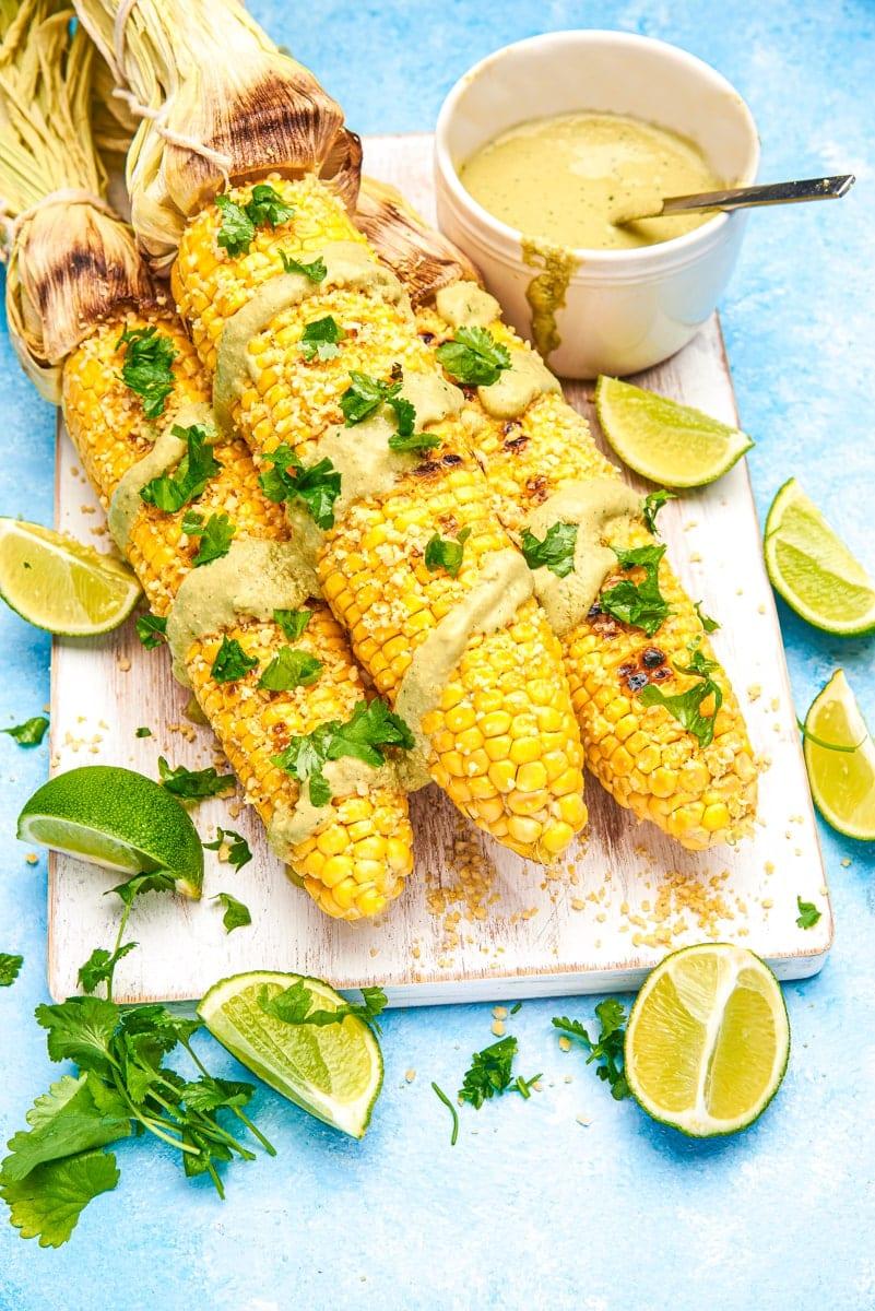 overhead shot of a platter of grilled chipotle corn on the cob at a BBQ