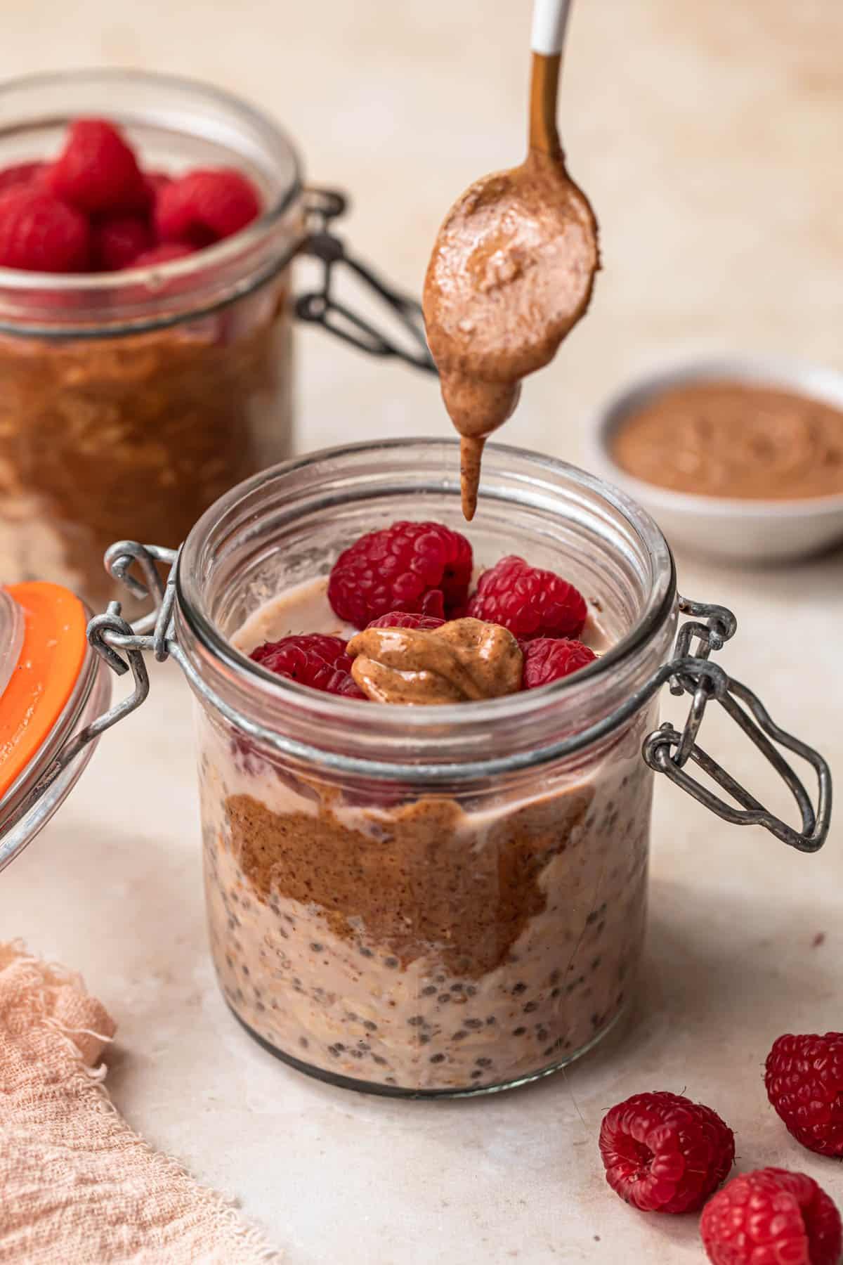 overnight oats being spooned from a jar