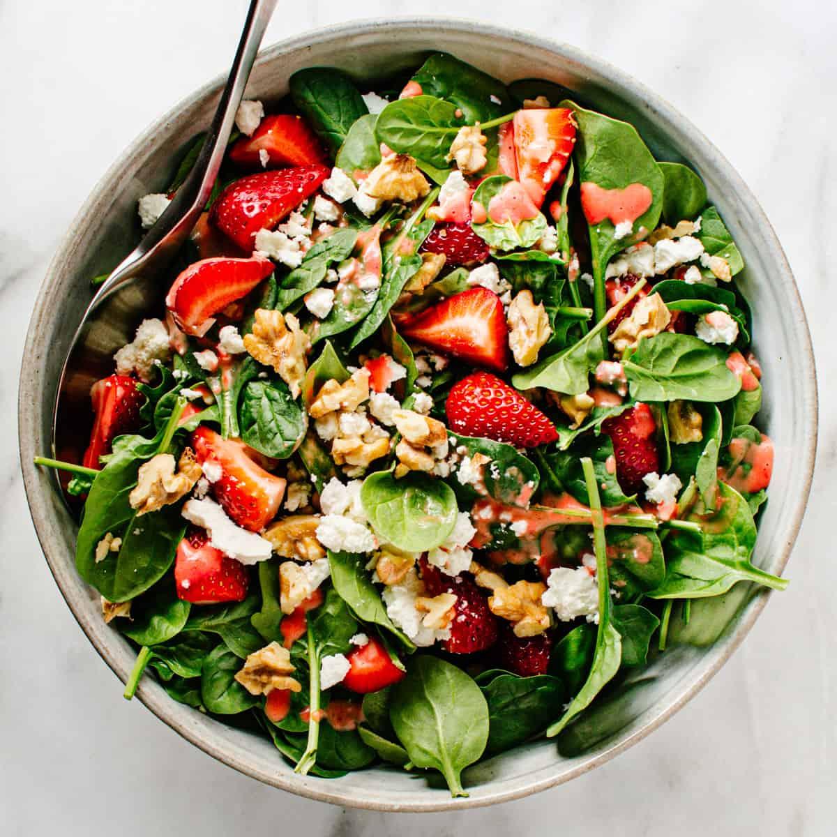 prepared strawberry spinach walnut salad in a bowl