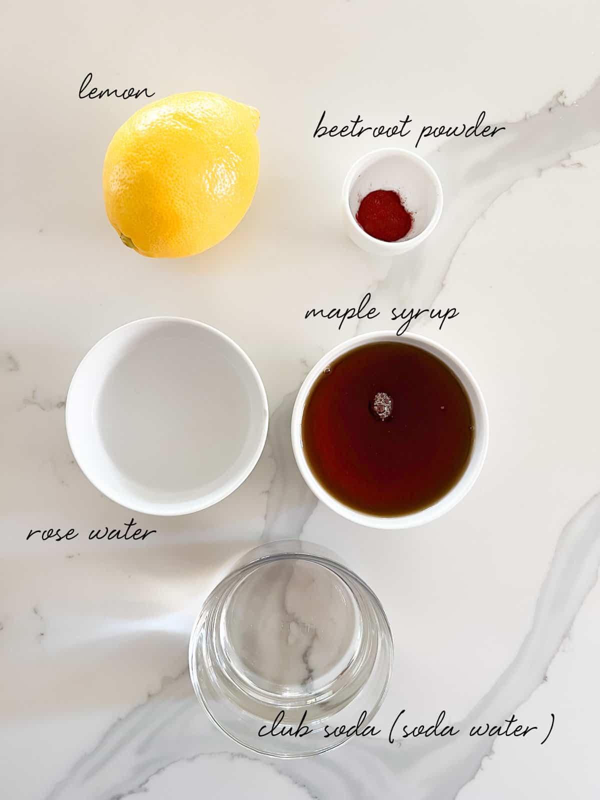 Ingredients for rose water fizz: rose water, pink salt, vanilla extract, sparkling water, lemon