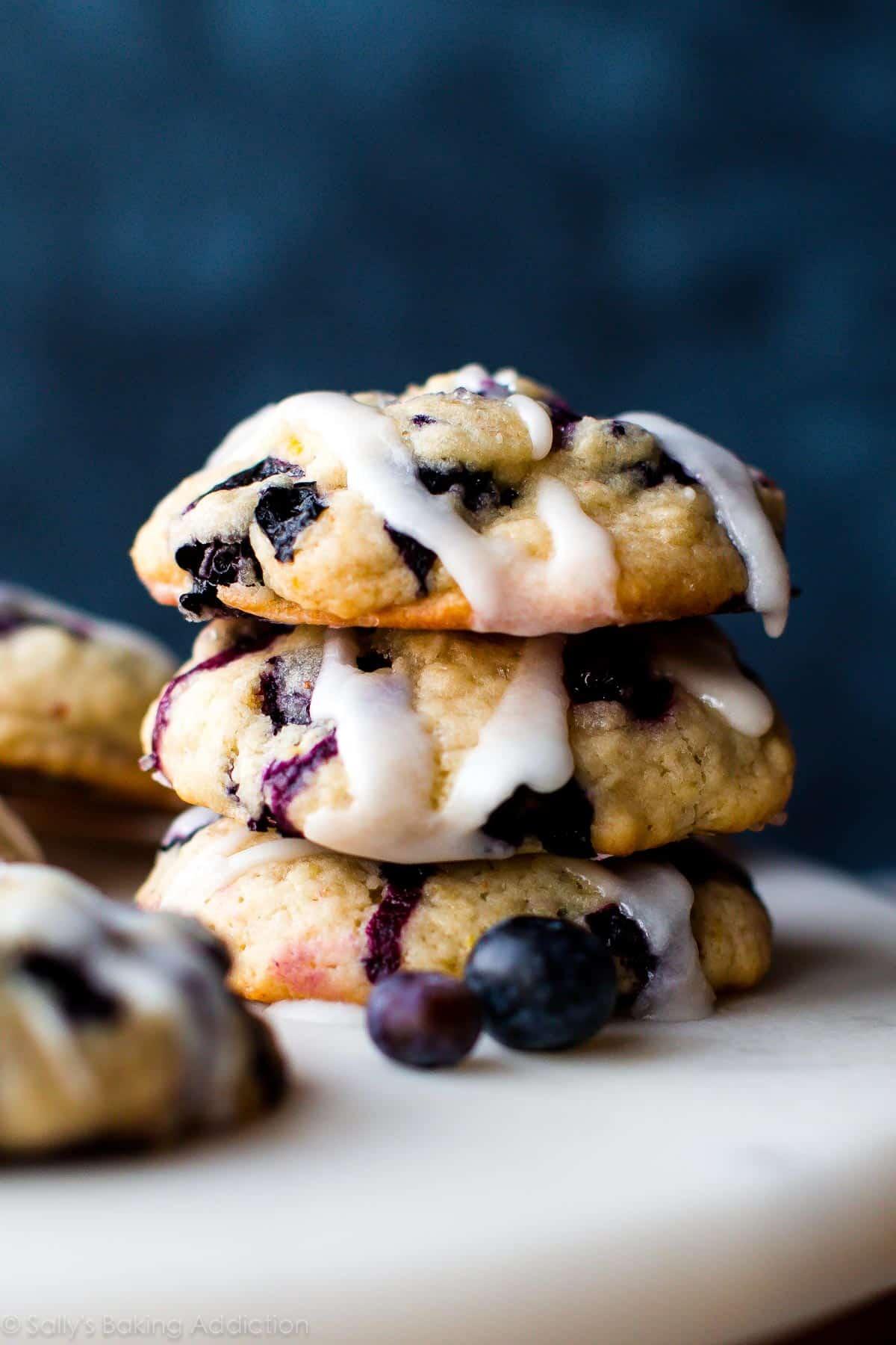 blueberry muffin top cookie being broken in half to show soft texture