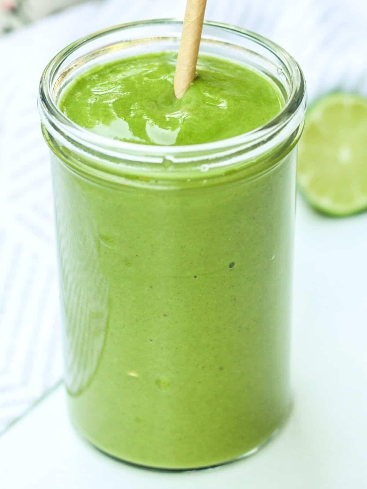 vibrant green smoothie with papaya chunks and spinach