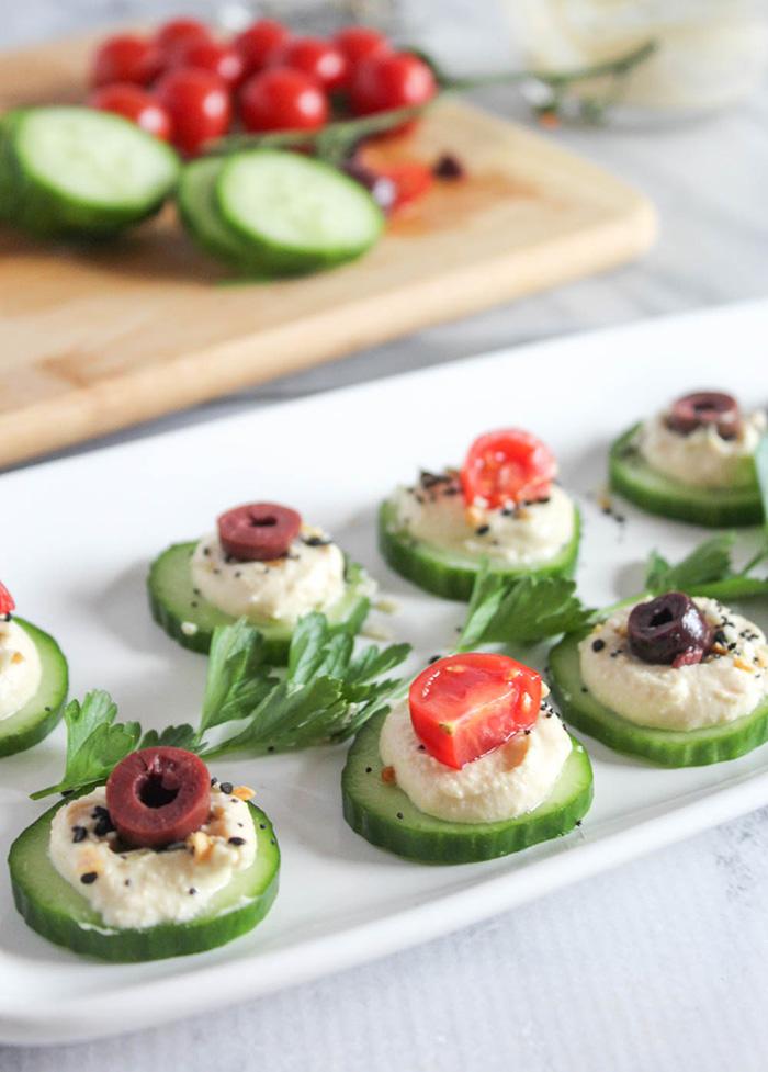 cucumber slices topped with hummus and various toppings