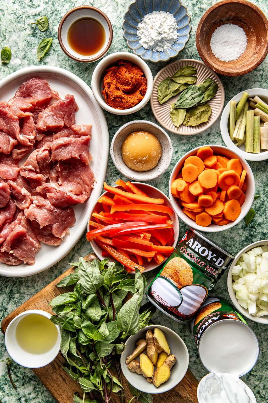 Ingredients for Panang curry crab cakes arranged on a wooden surface