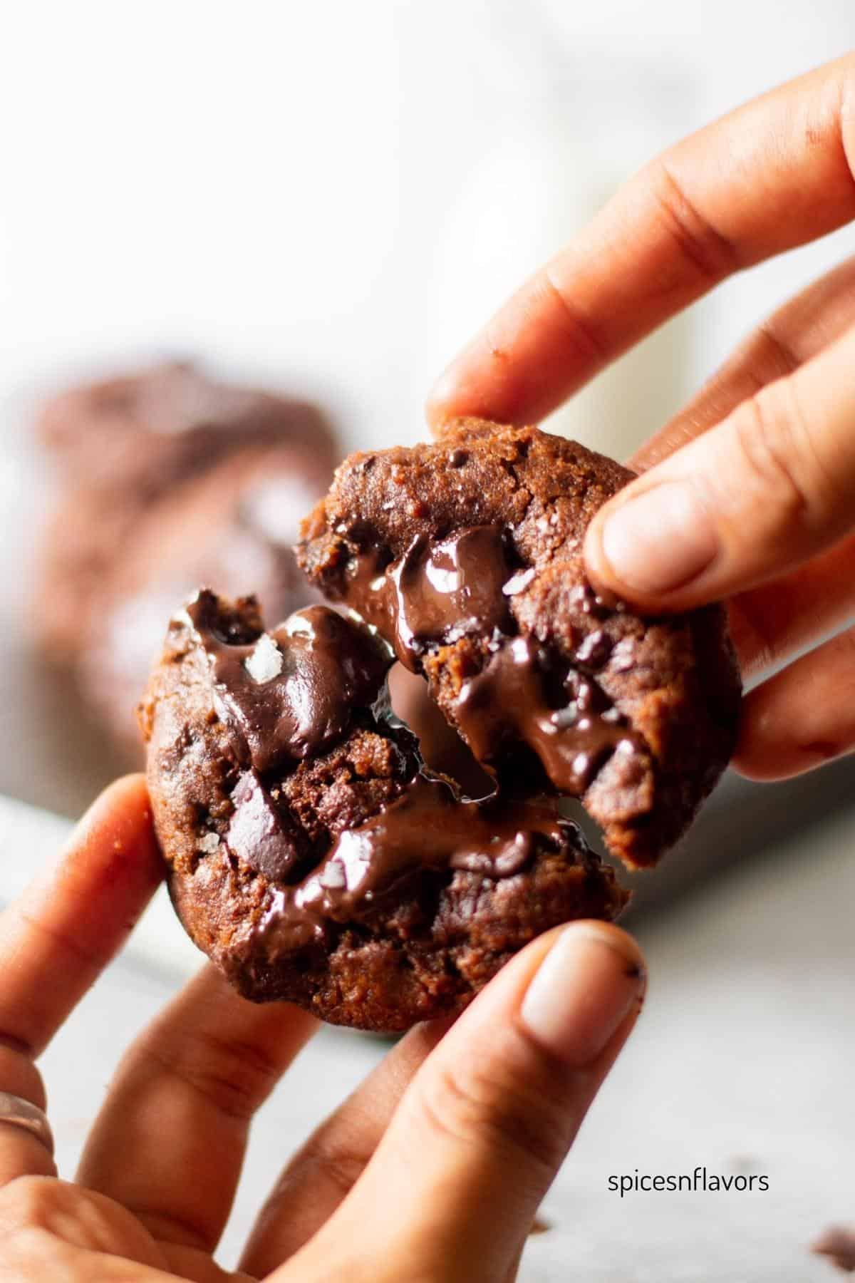 a hand reaching for a double chocolate espresso cookie