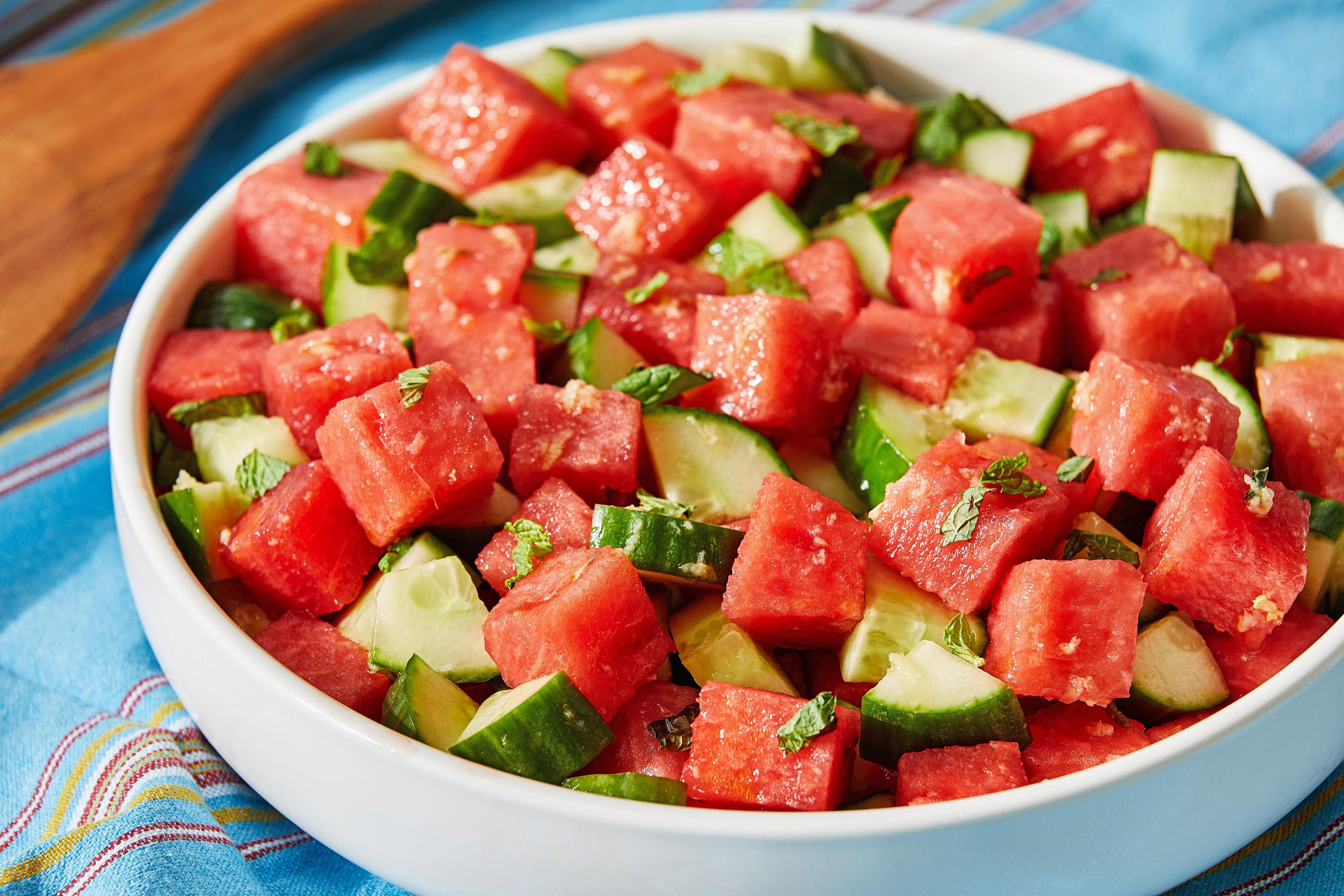 A vibrant Hawaiian watermelon cucumber pasta salad served outdoors on a sunny day