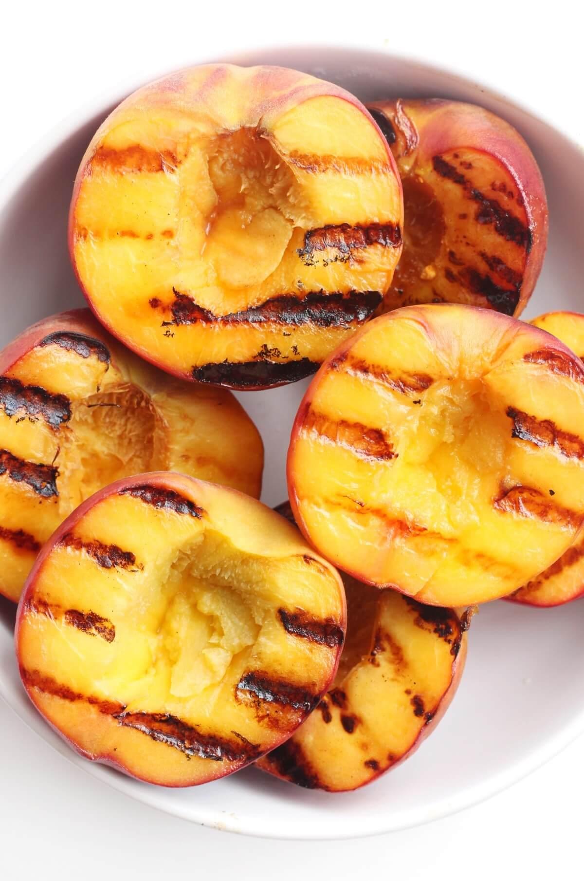 close up of grilled peach slices on a grill pan