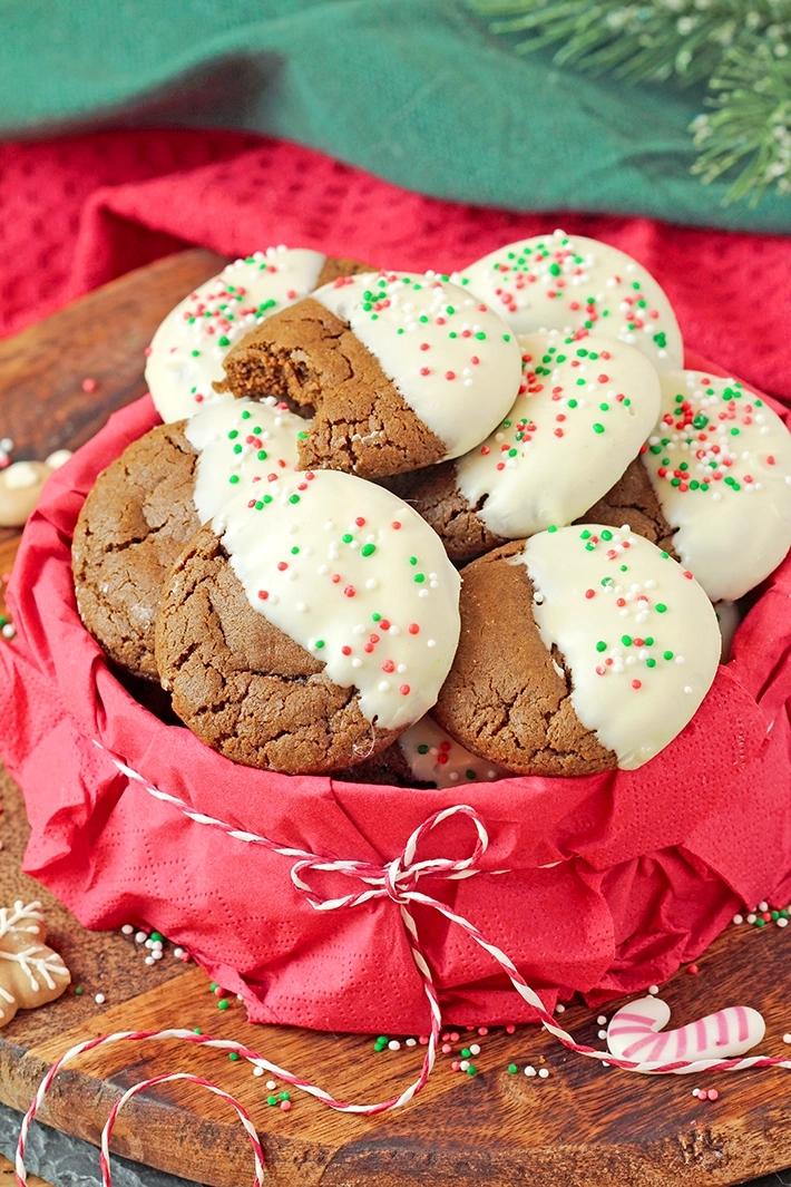 gingerbread cookies dipped in white chocolate with festive background, cozy kitchen, holiday decor