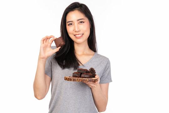 a smiling person holding a plate of eggnog brownies