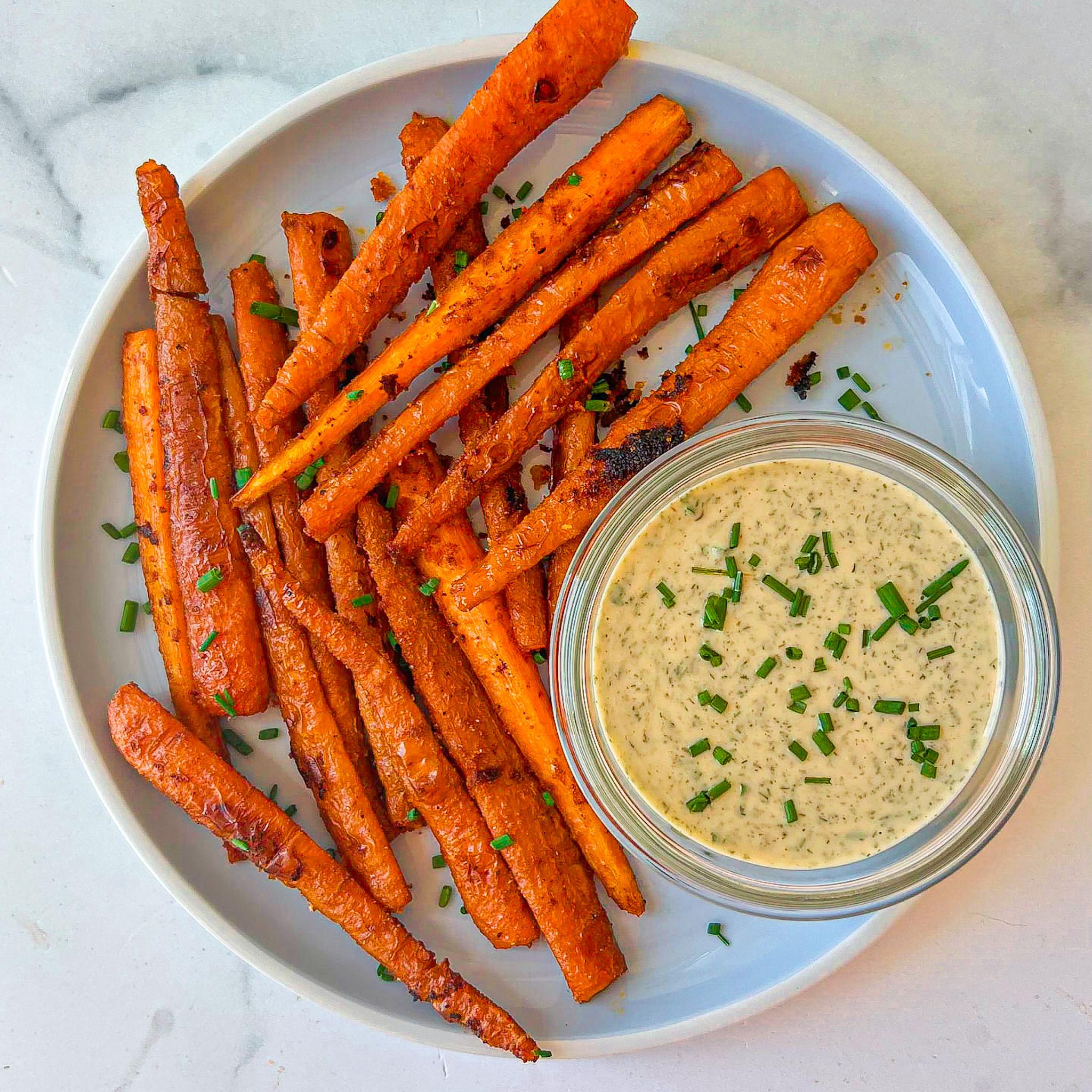 tahini dip in a bowl next to carrot fries