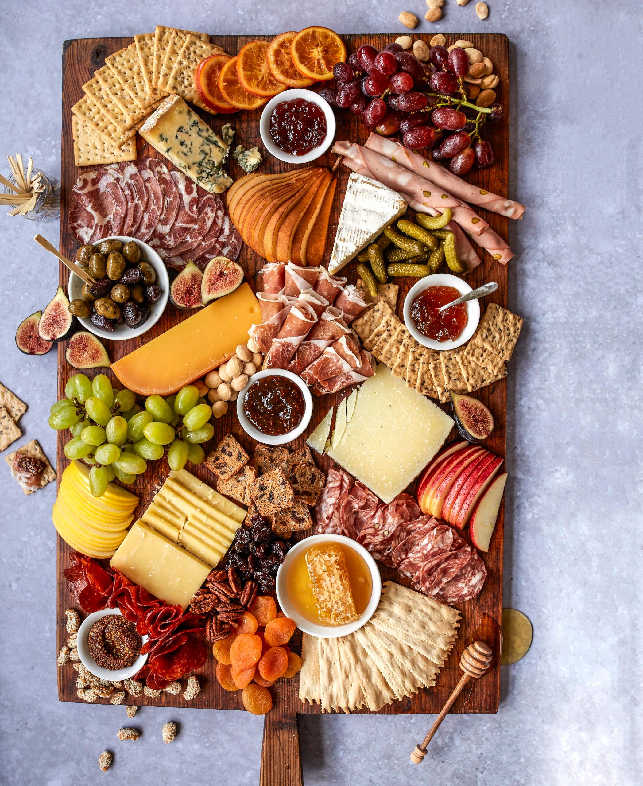 a beautifully arranged cheese flight on a wooden board