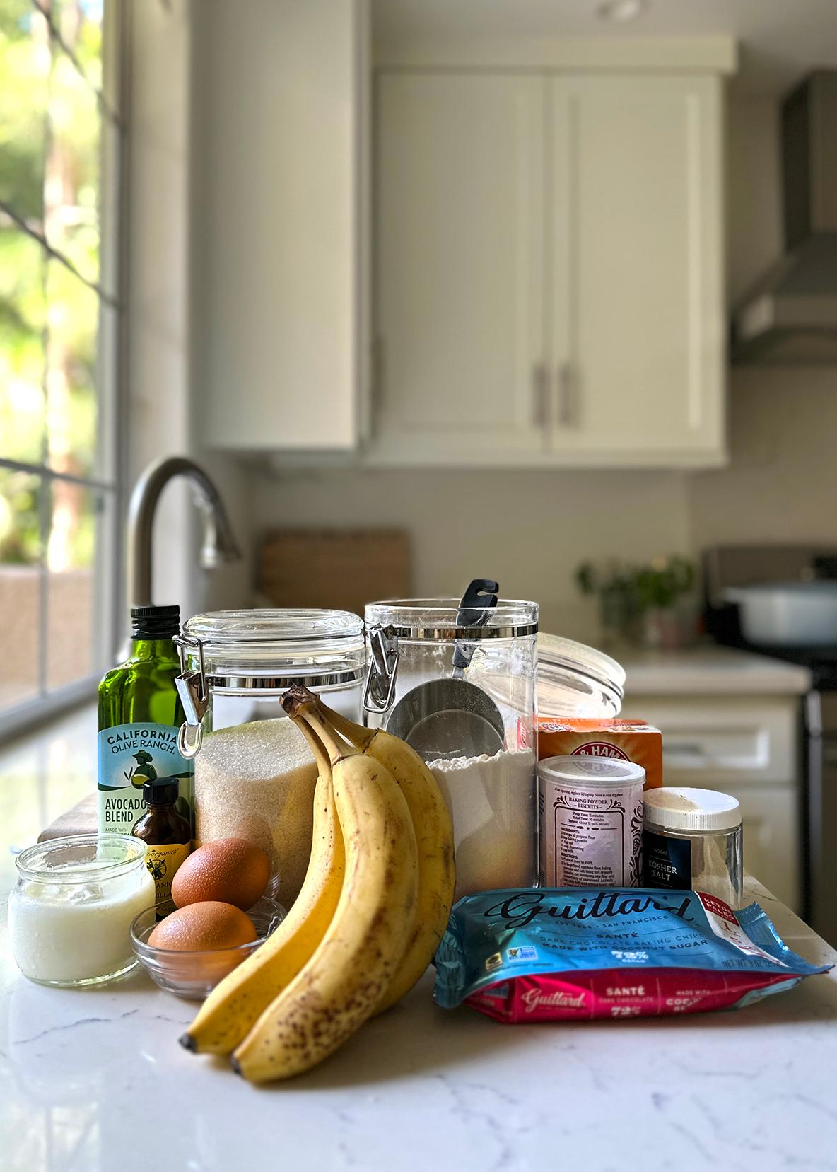 ingredients for a banana bread smoothie laid out on a kitchen counter