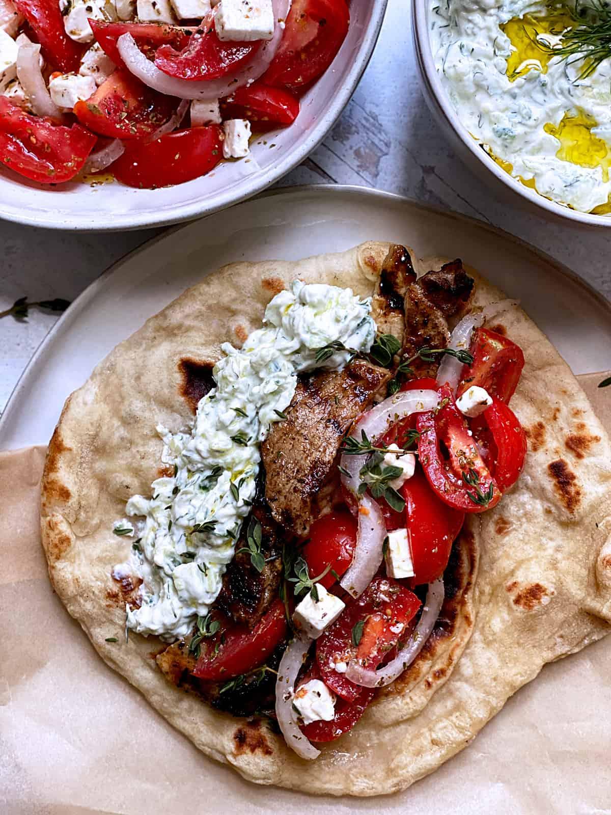 Lemony Chicken Souvlaki wrapped in pita bread with tzatziki sauce and fresh toppings