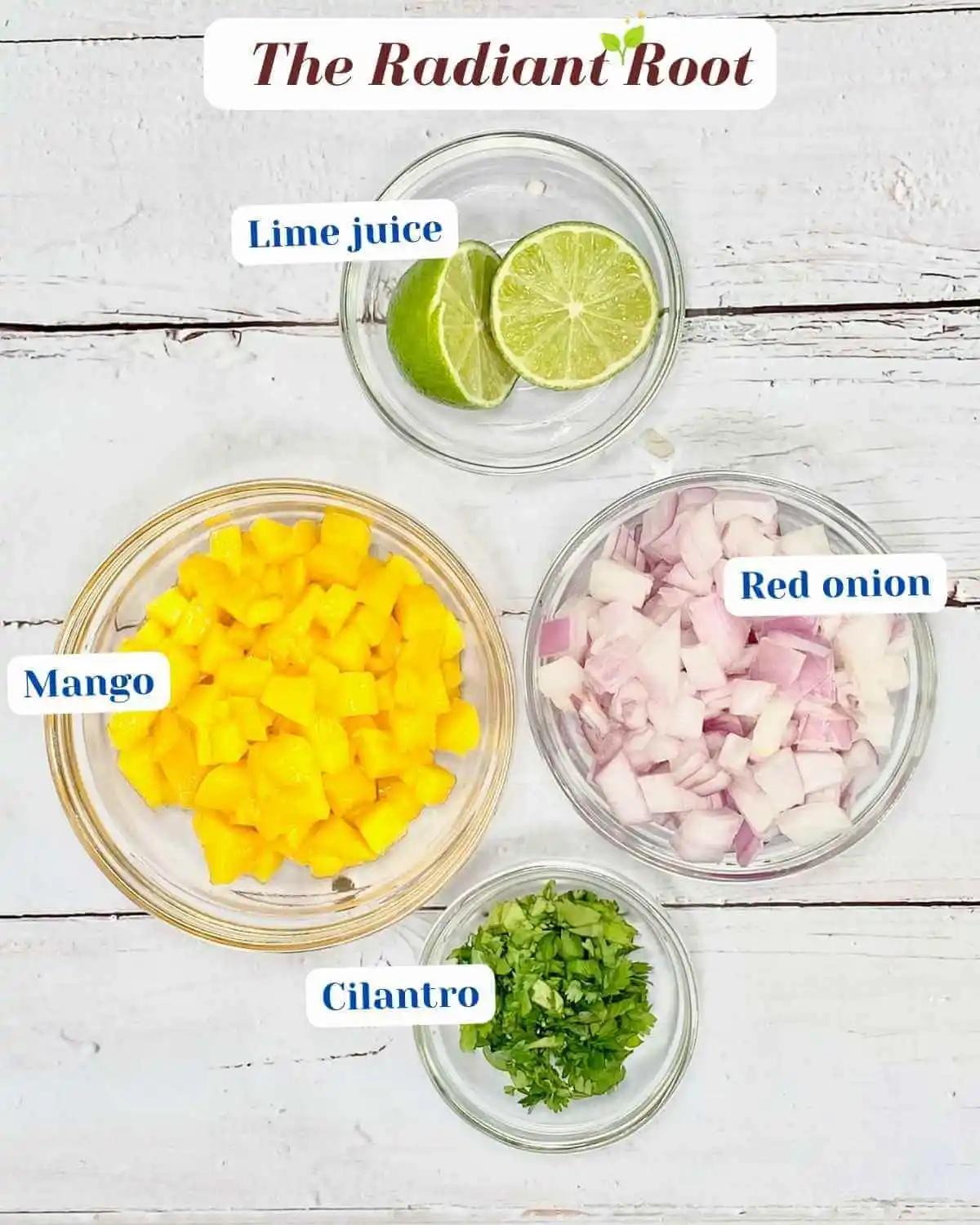 ingredients for mango salsa including diced mangoes, red onion, cilantro, and lime