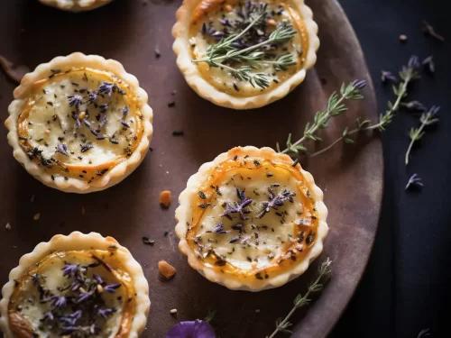 lavender blueberry goat cheese tart on a rustic wooden surface