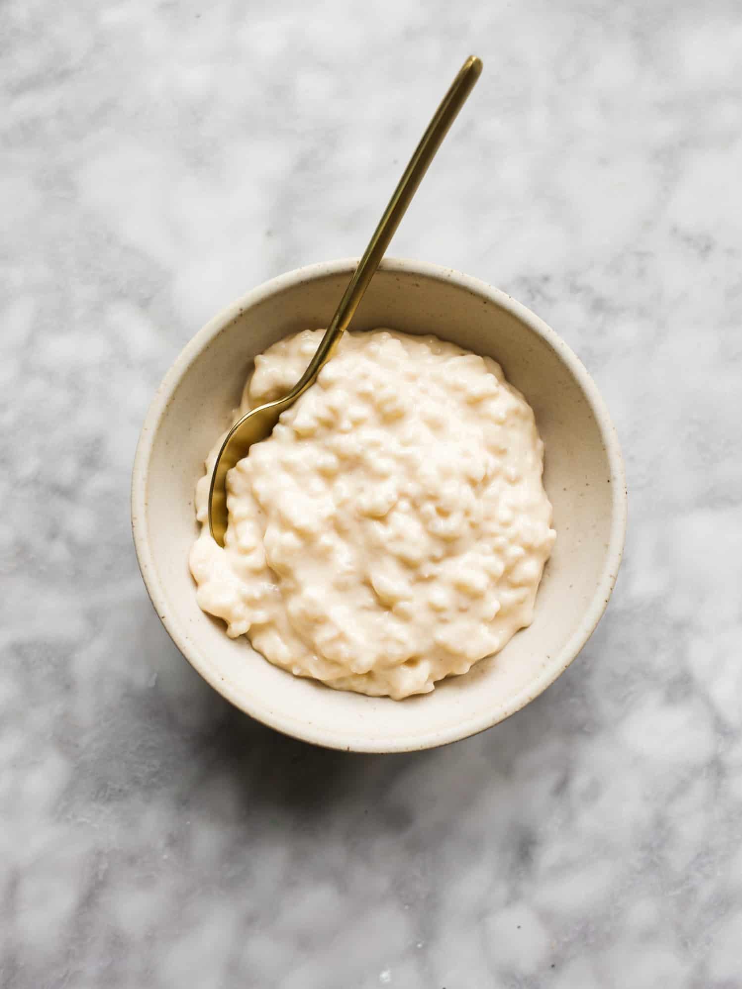 bowl of creamy rice milk with a sprinkle of pink salt