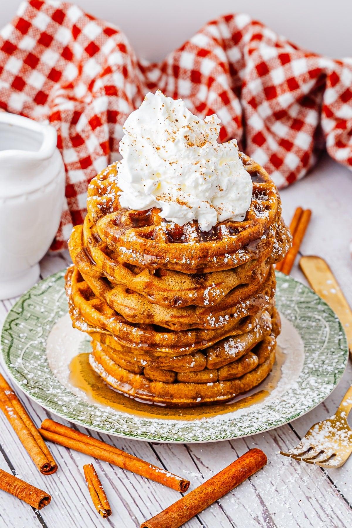 gingerbread waffles topped with whipped cream and gingerbread crumbles