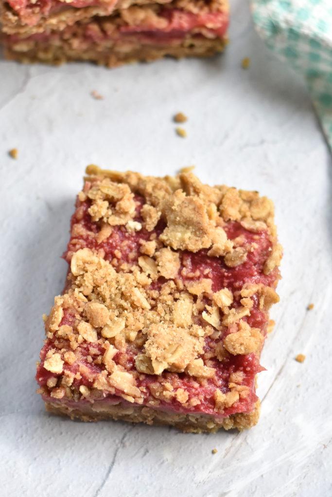 a plate of rhubarb bars being served at a picnic