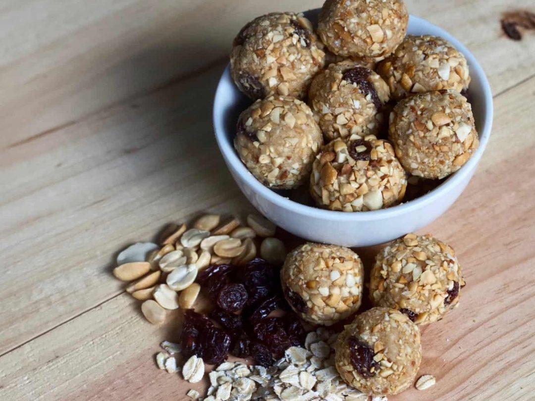 mixing ingredients for raisin peanut butter protein hearty in bowl