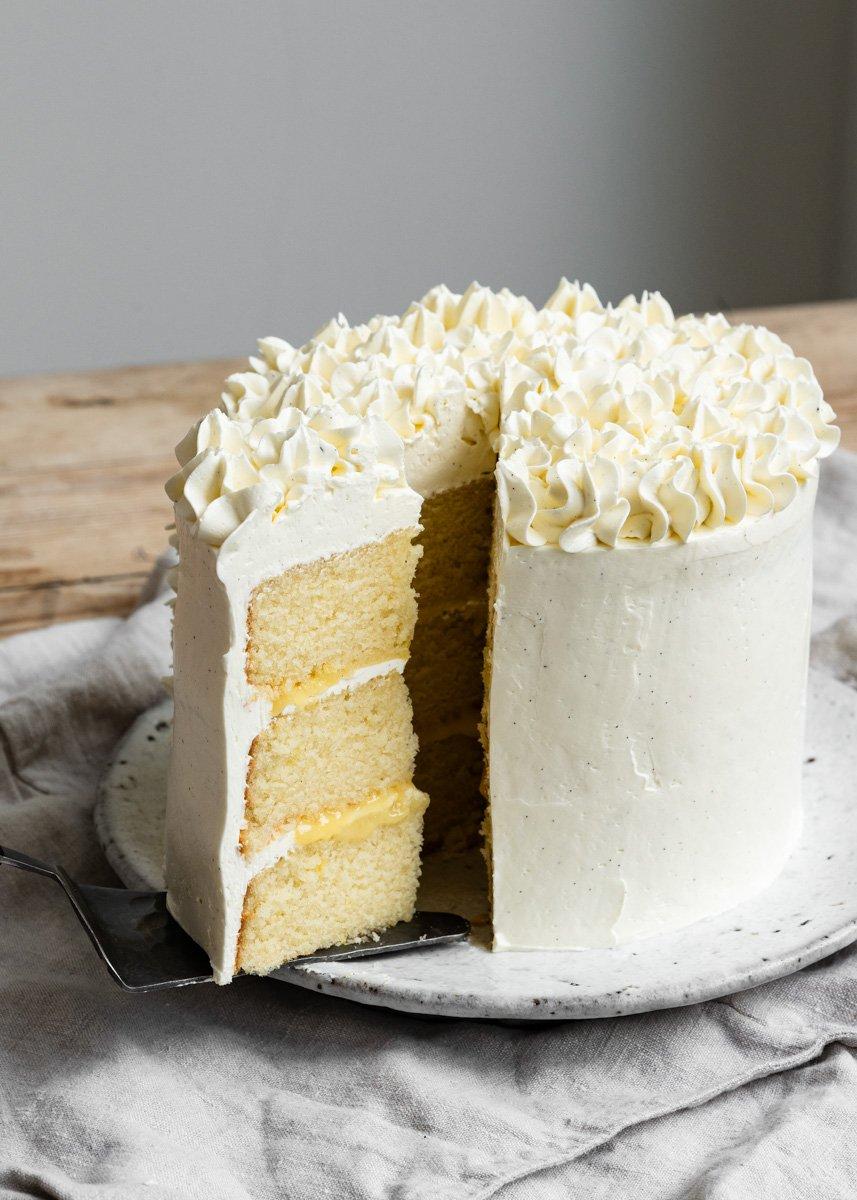 Close-up of a slice of Elderflower Vanilla Cake showing the crumb and frosting