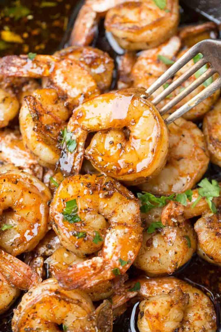 Close-up shot of garlic shrimp being sautéed in a pan