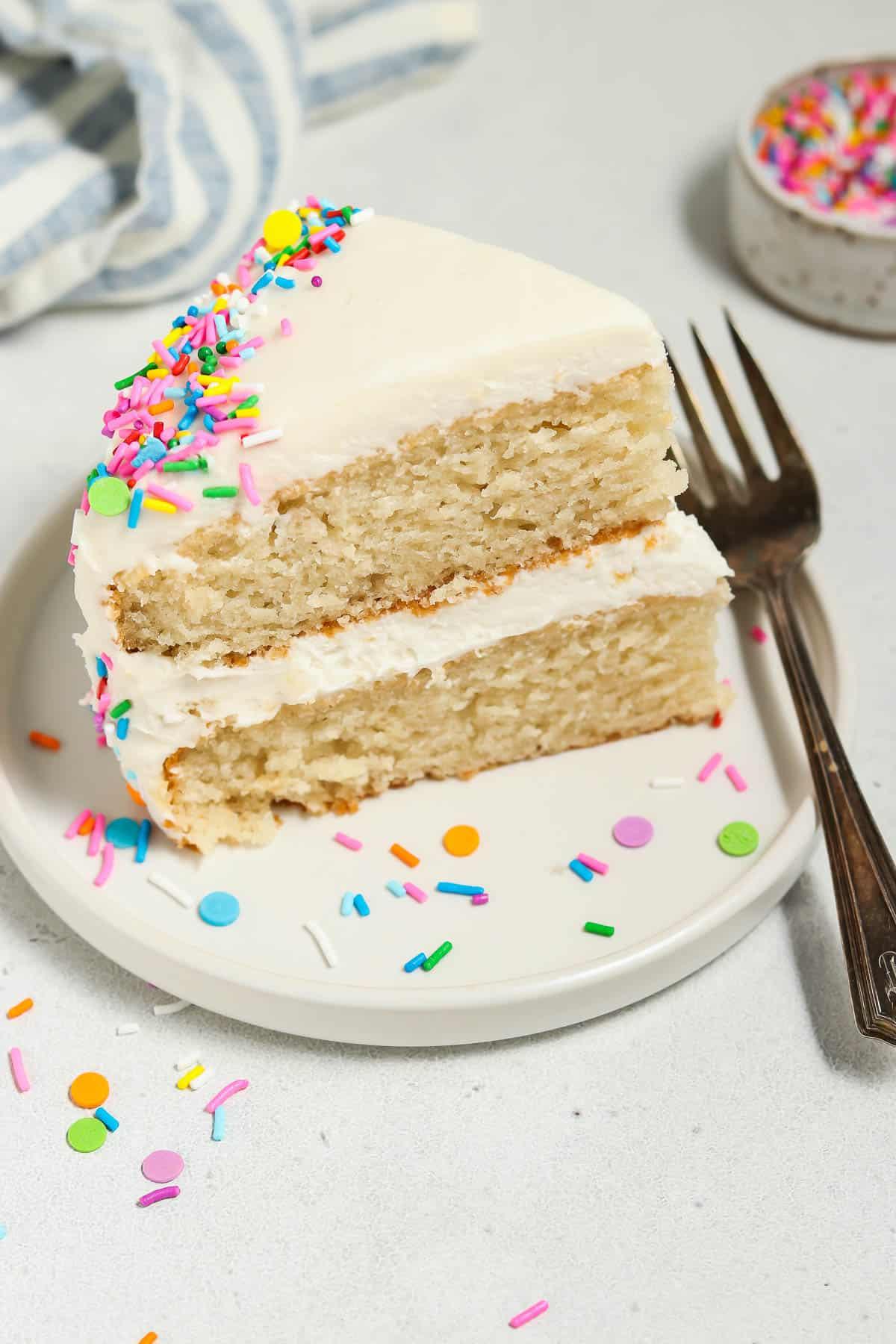a slice of vanilla birthday cake with soy sauce on a plate