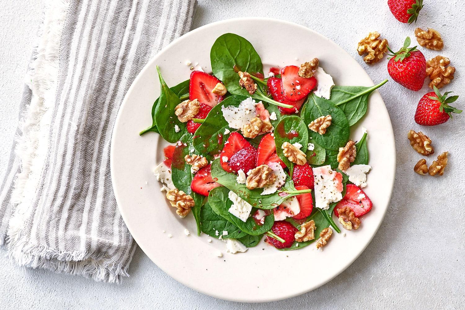 fresh strawberry spinach salad with walnuts and vinaigrette