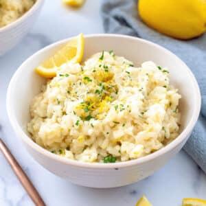 close-up shot of lemon garlic risotto being served in a white bowl