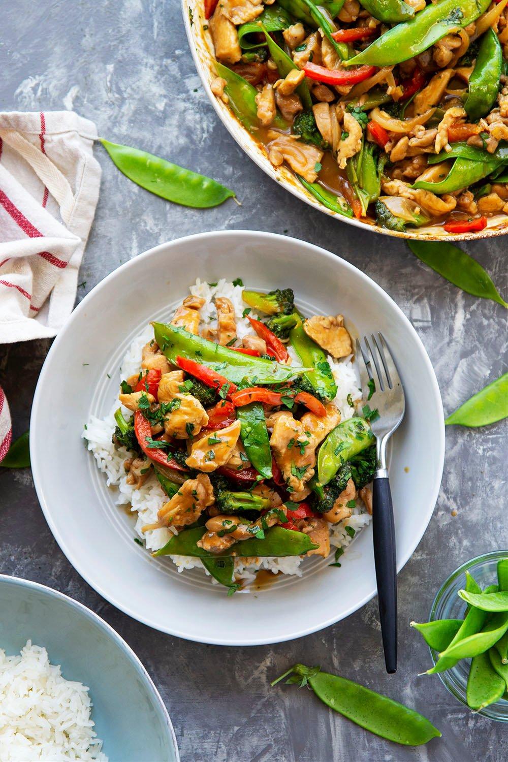 Peanut satay chicken and spinach stir-fry in a wok