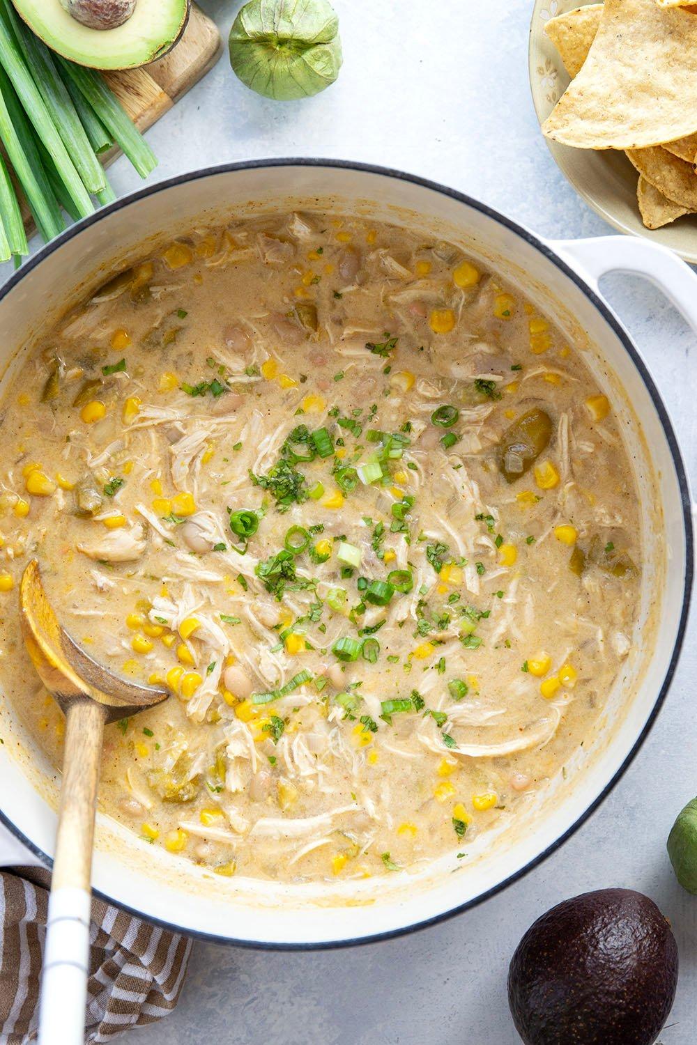 Close-up shot of white chicken chili simmering in a pot on the stove