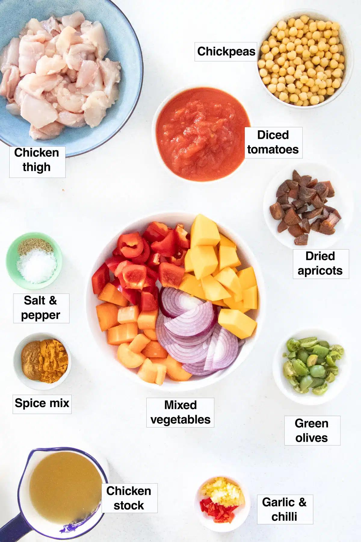ingredients for vegetable tagine laid out on a wooden table