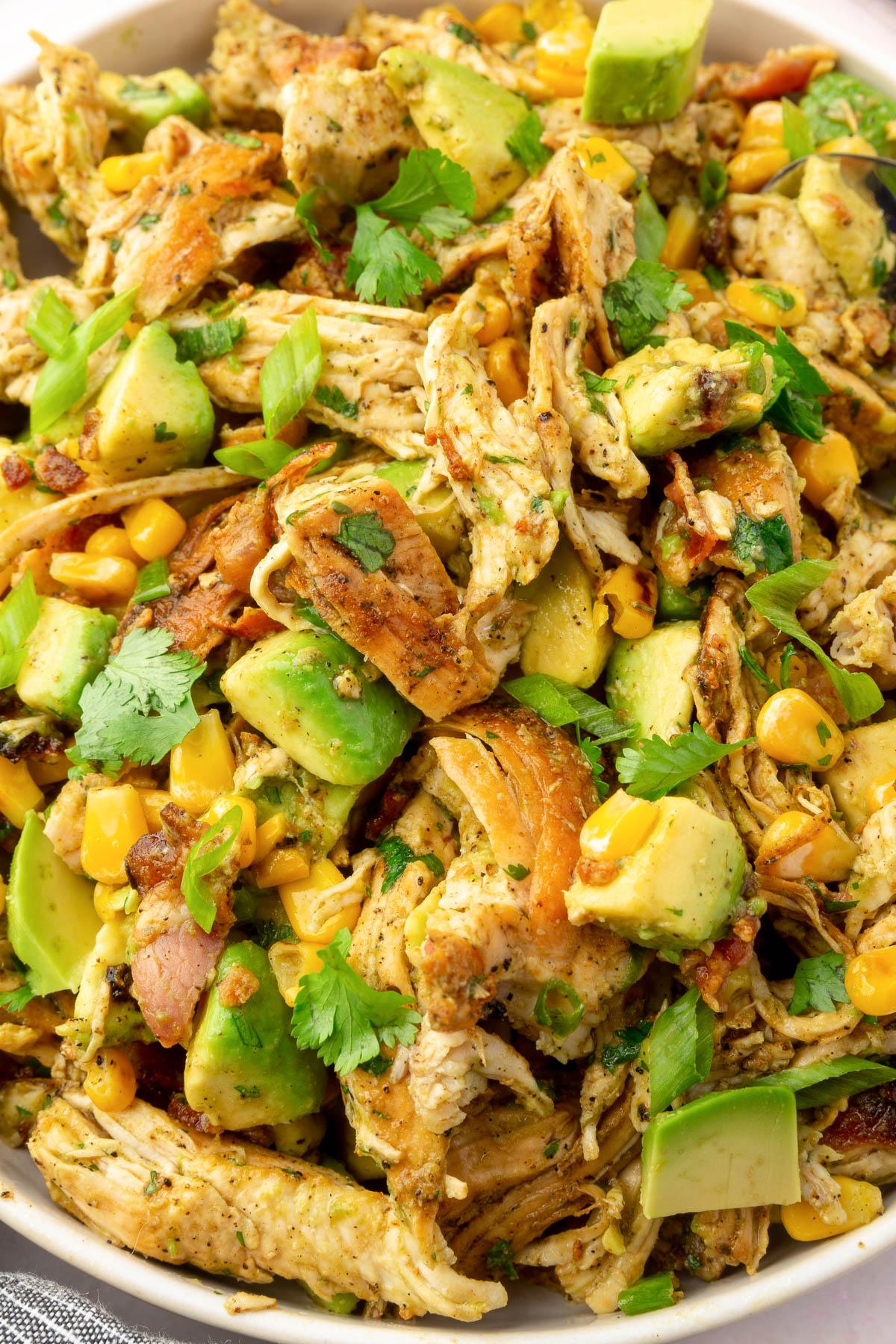 a prepared chicken and avocado salad in a bowl ready to be served
