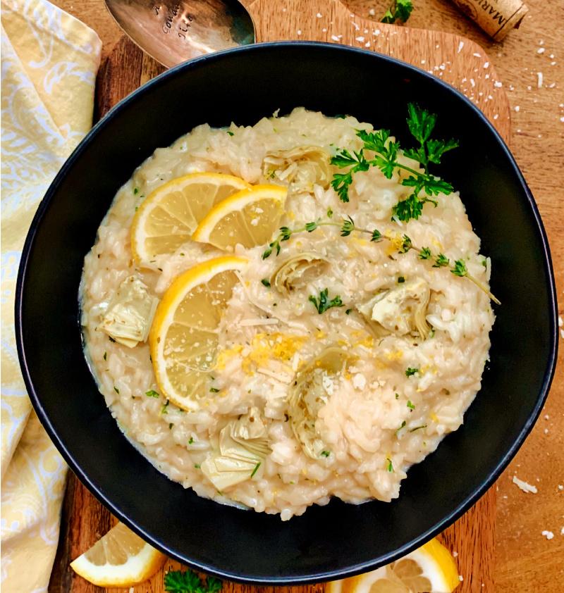Overhead view of a pot of risotto simmering on a stove, with granita ingredients nearby.