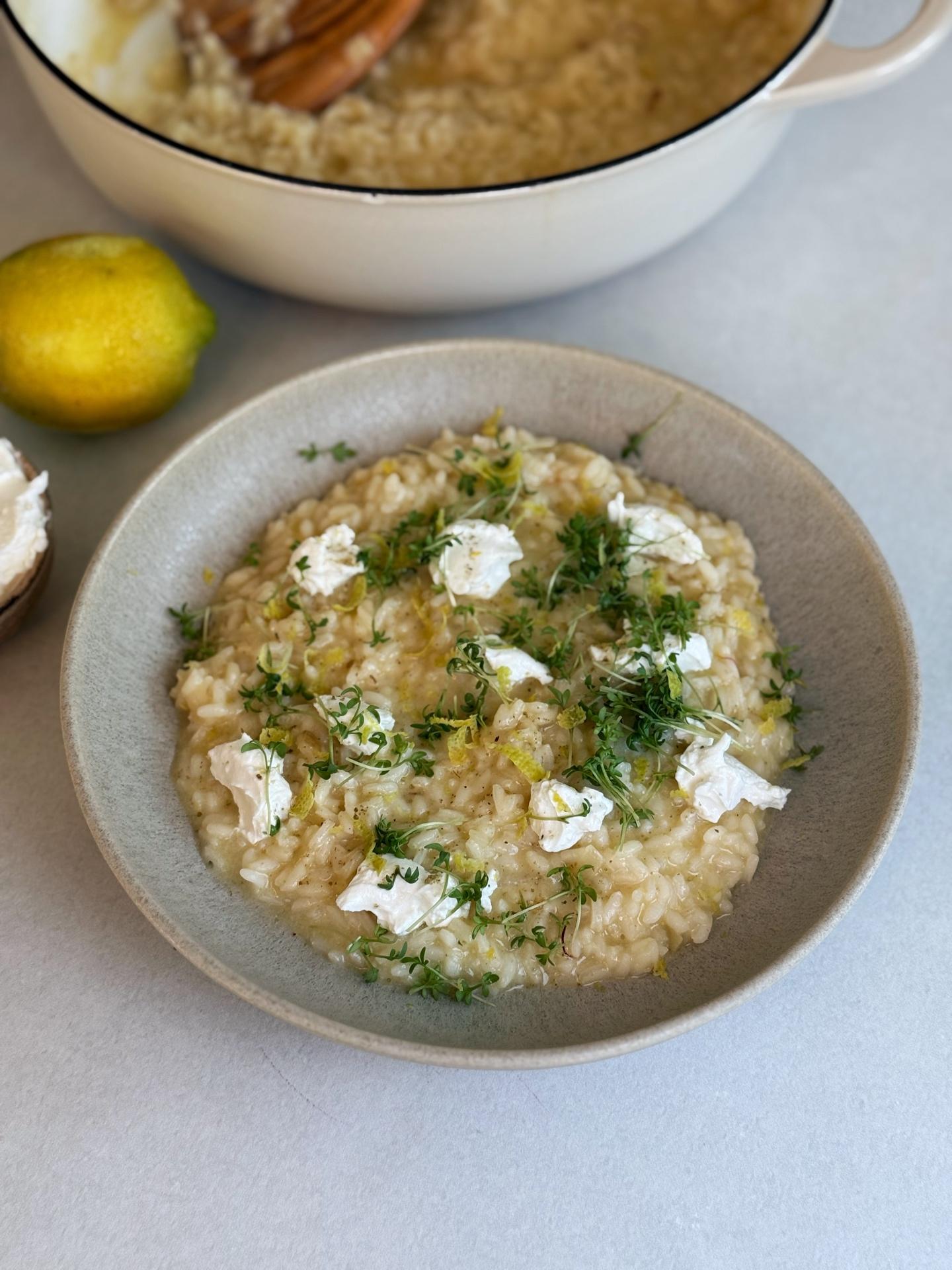 Close-up shot of yuzu fruit being zested over a pot of creamy risotto