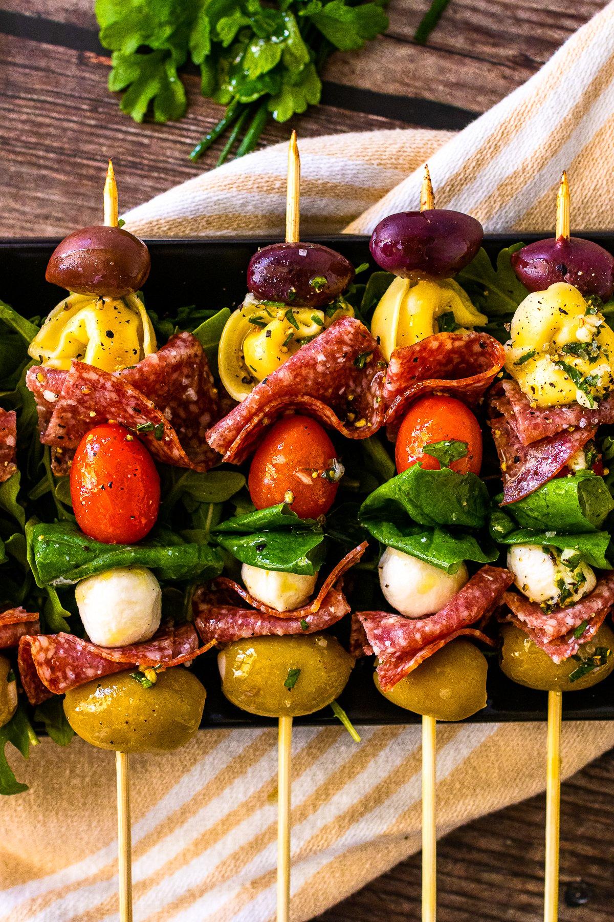 people enjoying a barbecue with antipasto skewers