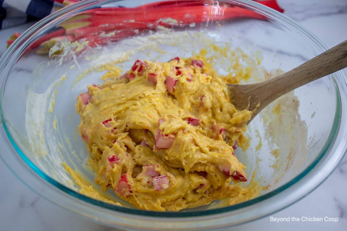 close-up of batter being mixed in a bowl for peach rhubarb bread