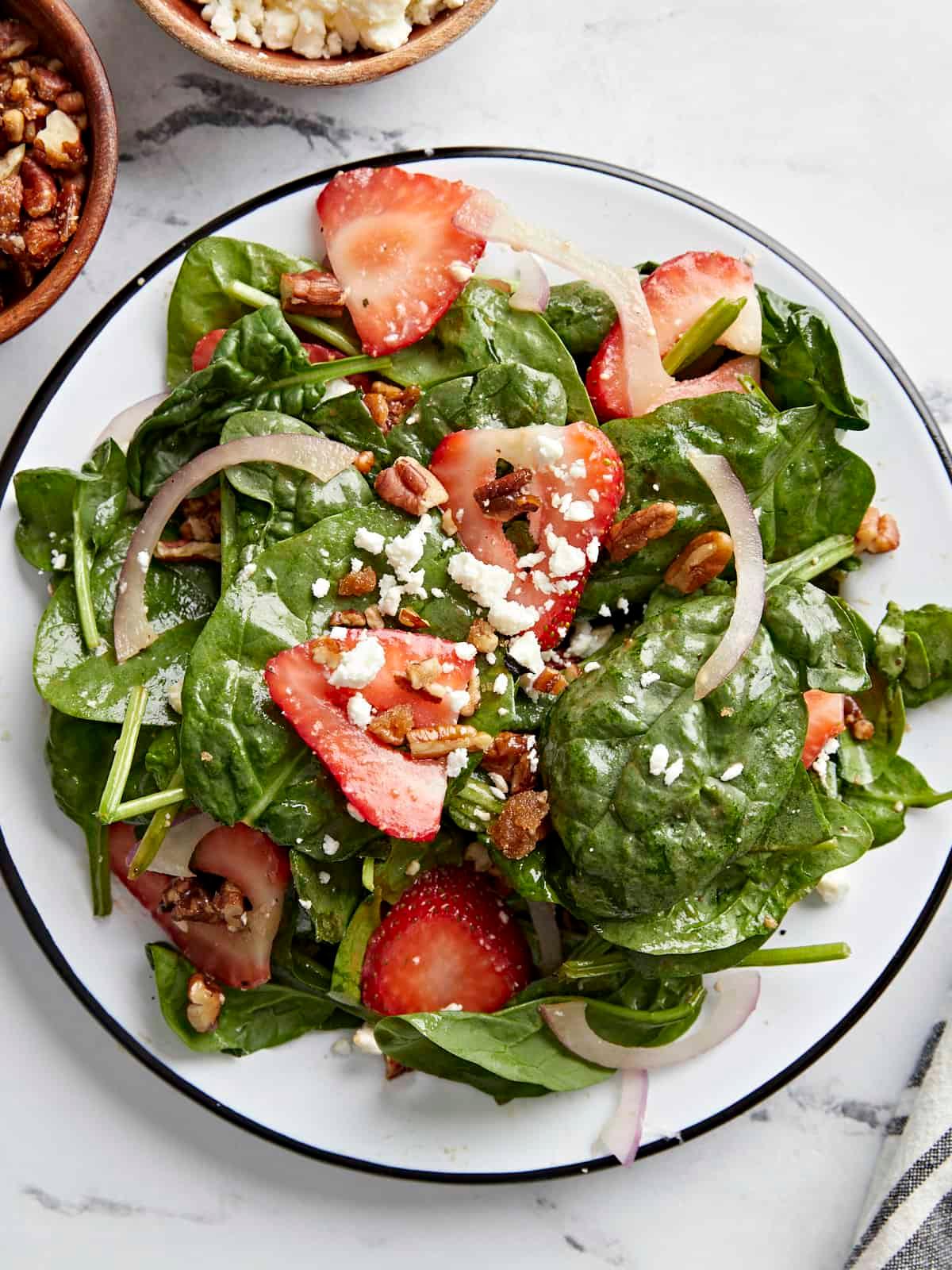 close-up of strawberry slices on a bed of spinach