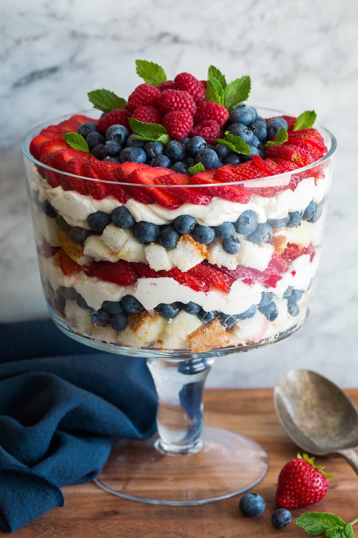layered berry trifle dessert in glass bowl