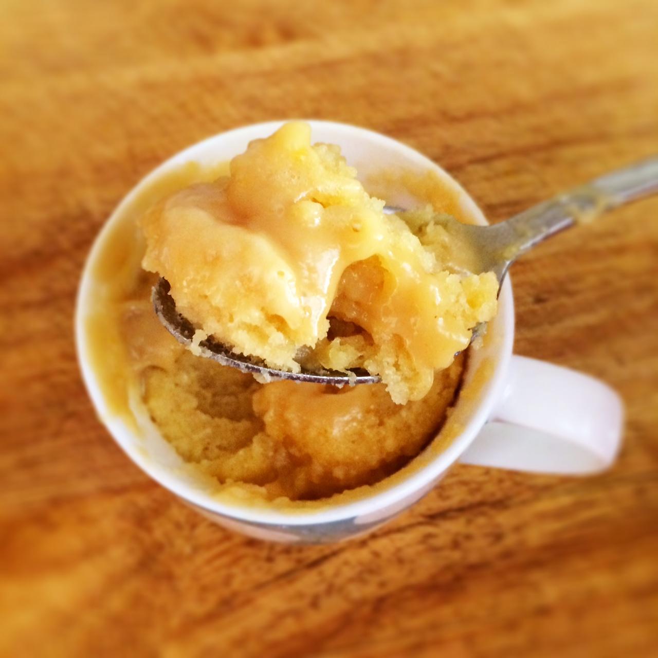 person enjoying a salted caramel mug cake on the couch