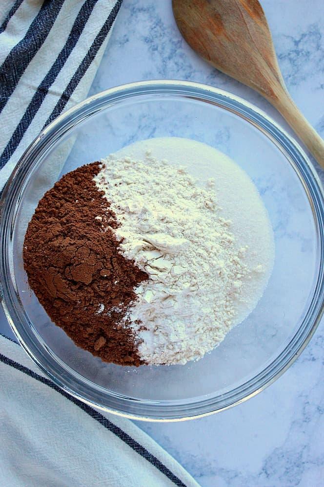 overhead shot of mixing ingredients for chocolate cake in a bowl